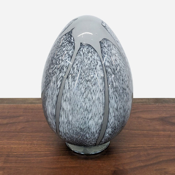 a black and white vase with a large white and gray design.