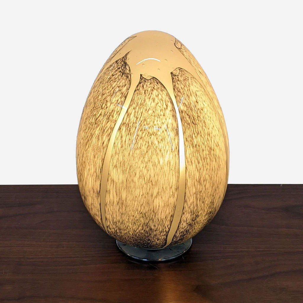 a gold egg on a wooden table