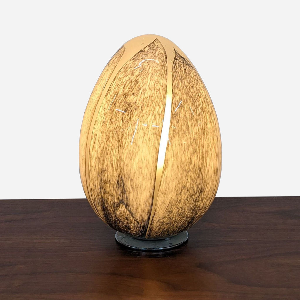 a wooden egg shaped lamp with a carved shell