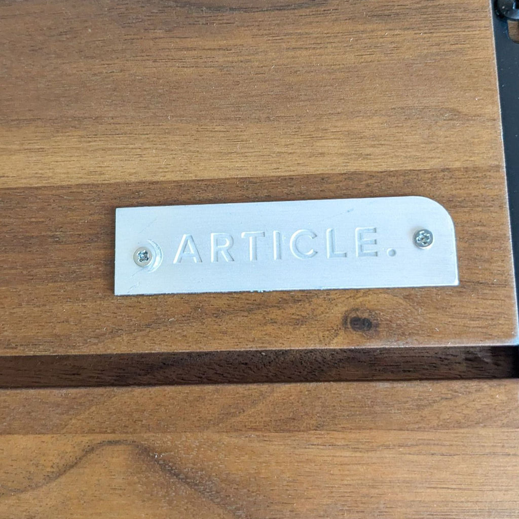 the metal plate on the side of the bench says ` ` article''.