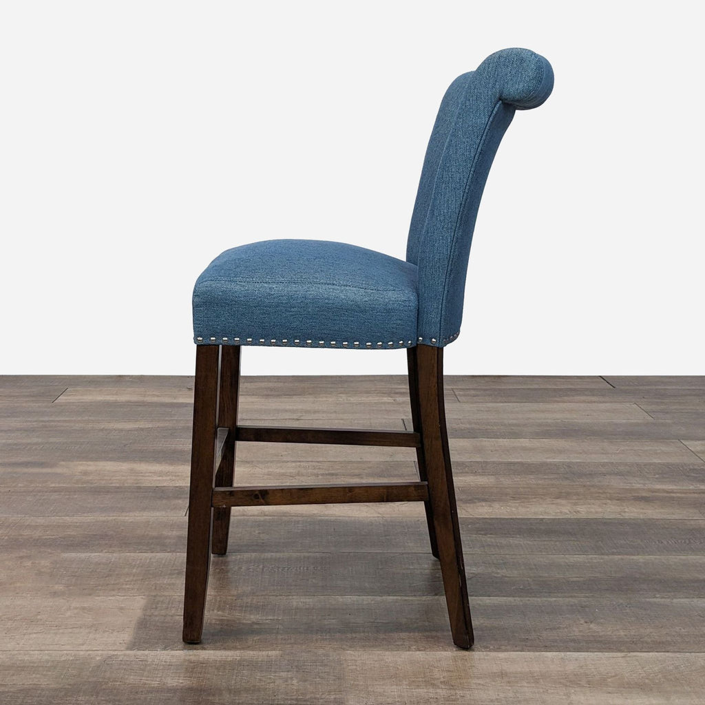 a blue denim dining chair with a backrest and a wooden back.