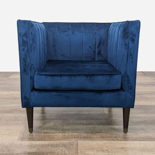 a pair of blue velvet armchairs