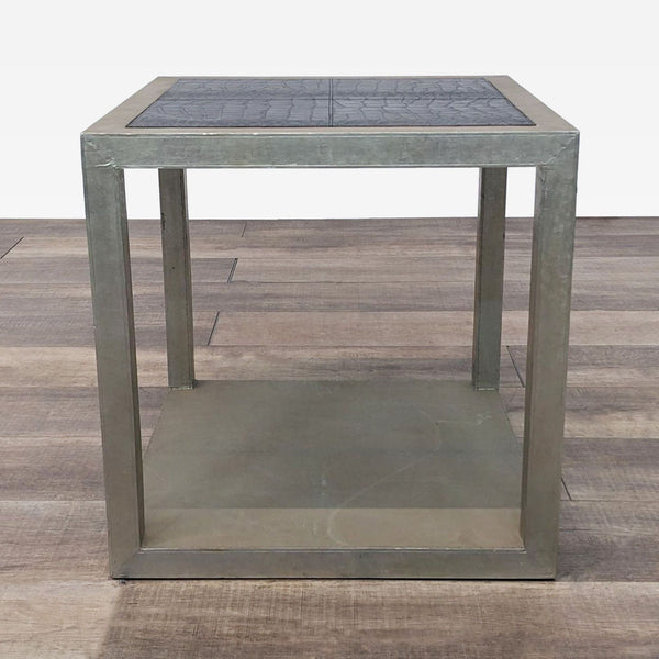 a modern, industrial style side table with a square top.
