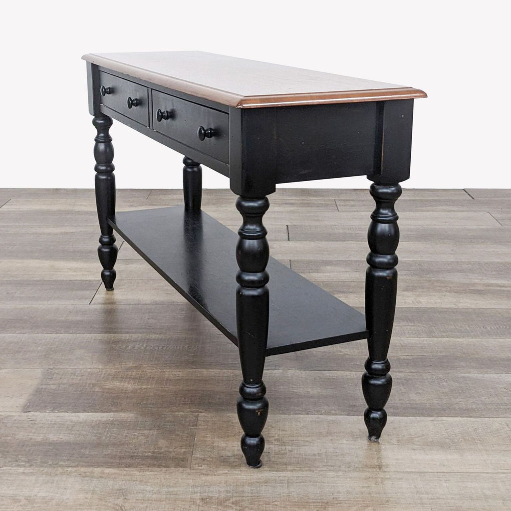 a black painted wood and iron table with a shelf