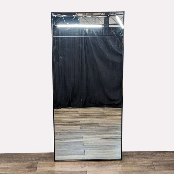 a large mirror with a black curtain and a black curtain.