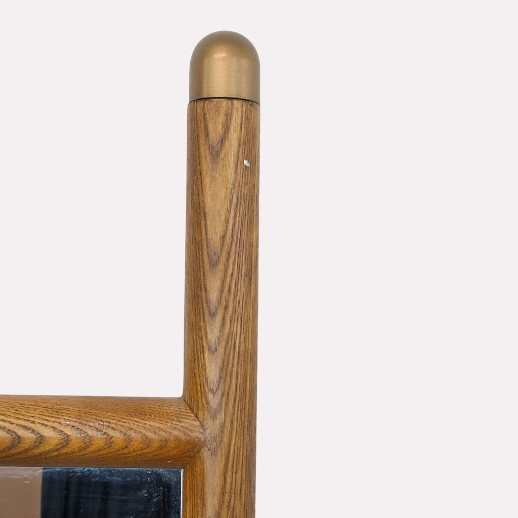 2. Close-up of brass metal accent and pecan-finished wooden dowel on Williams Sonoma mirror.