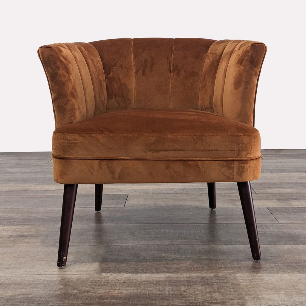 Front view of a rust velvet lounge chair with tufted back and tapered wood legs.