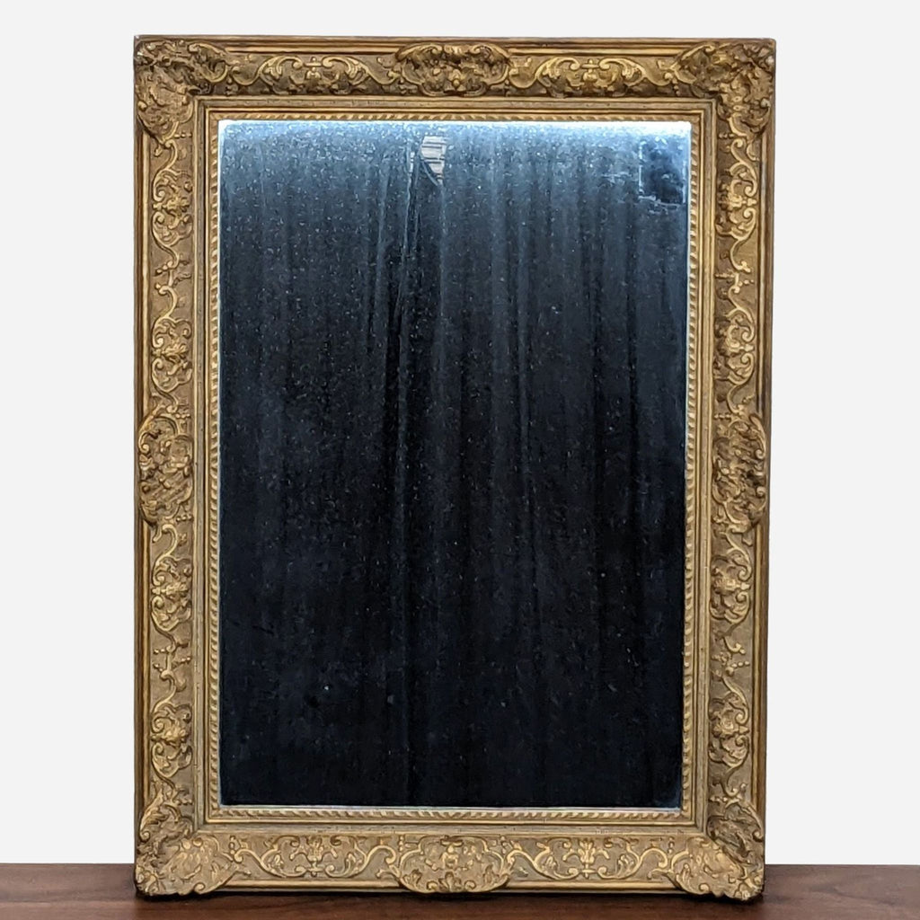 a large, gilded mirror with a black frame.