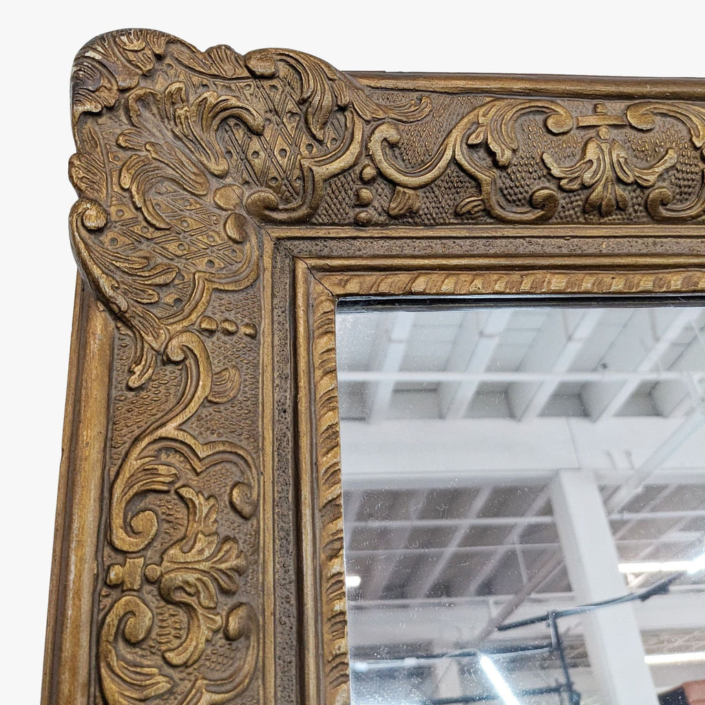 a large antique gold framed mirror with a floral design.