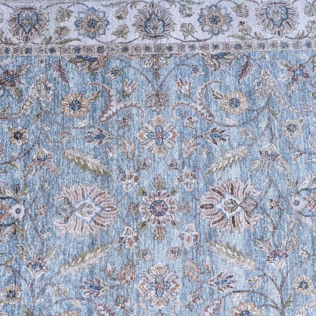 a close up of a blue and white oriental rug
