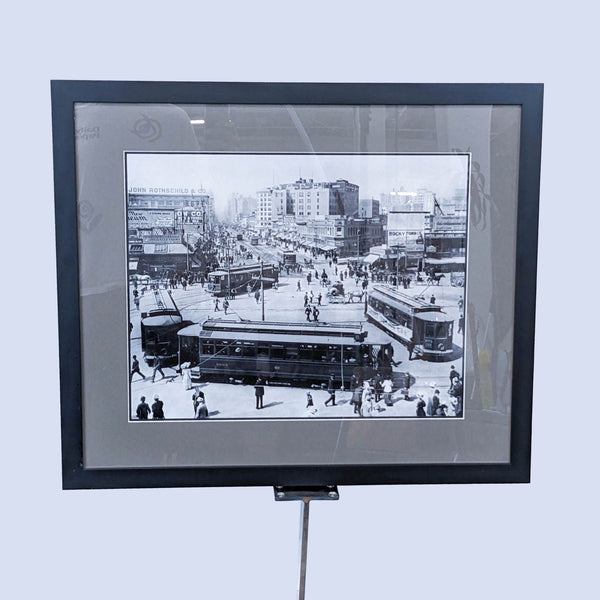 a framed photo of a city street scene.
