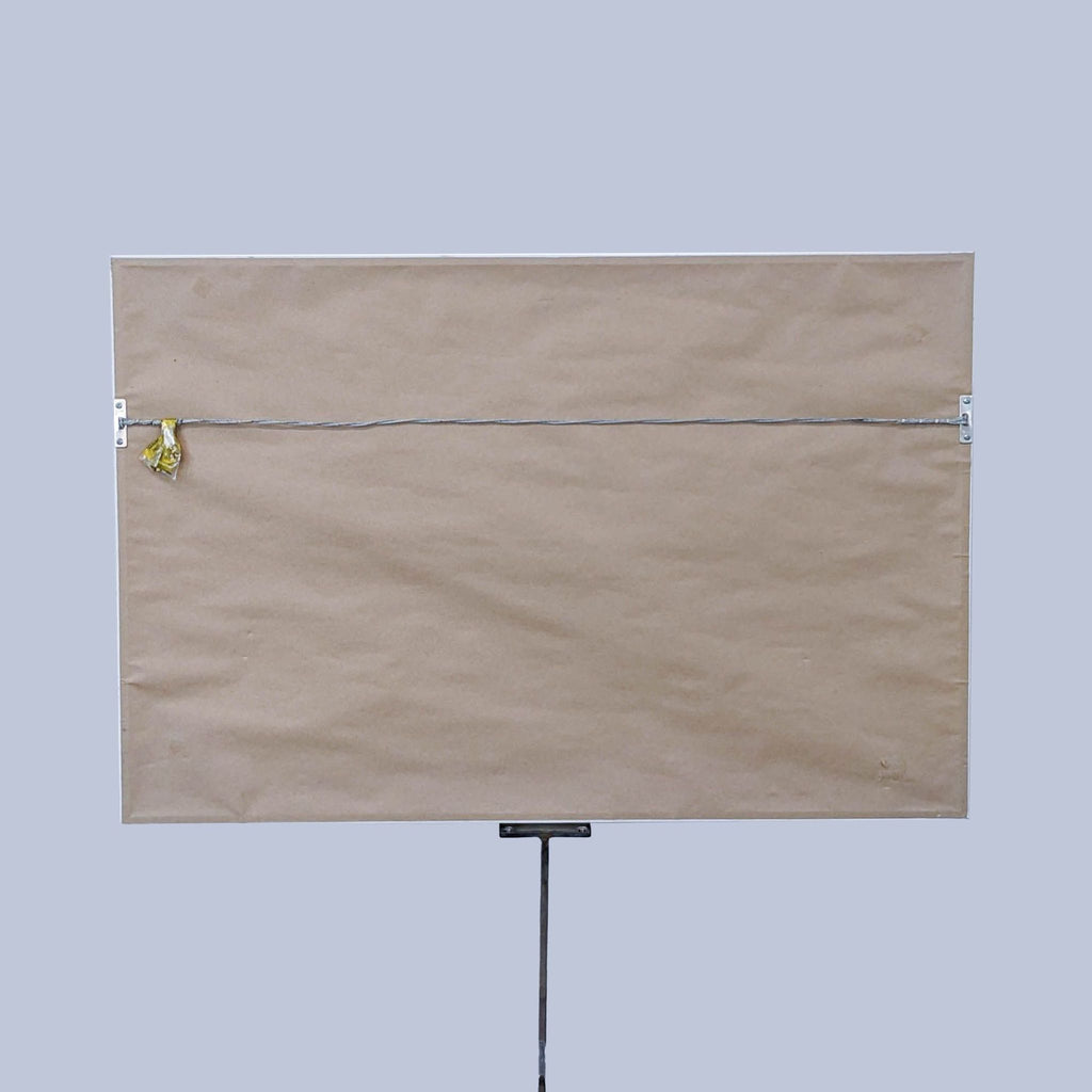Back view of framed abstract art with hanging wire.