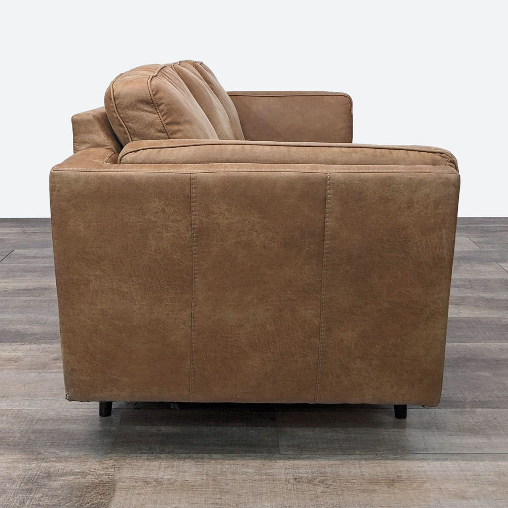 a brown leather chair with a backrest and a footrest.