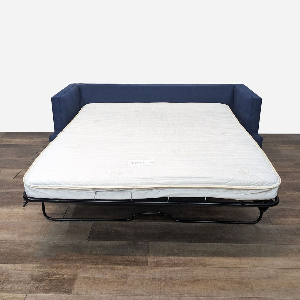 a mattress on a wooden floor.