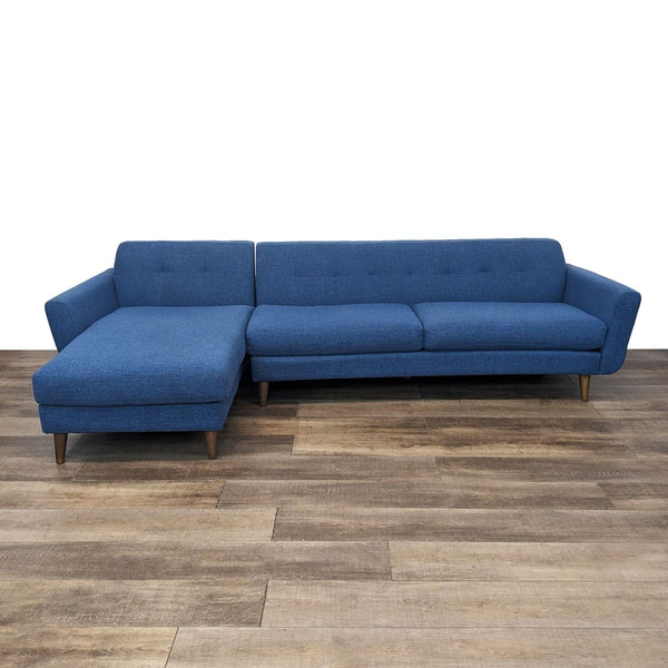 the blue sofa is a modern design that is made of soft fabric. the sofa is made of