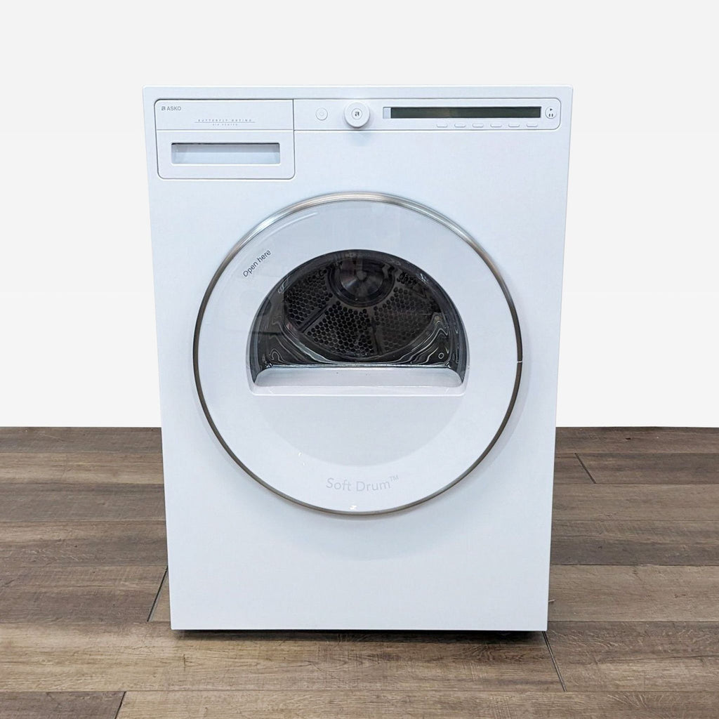 a washing machine on a wooden floor.