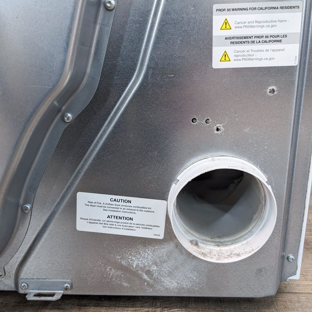 a white refrigerator with a black cover 