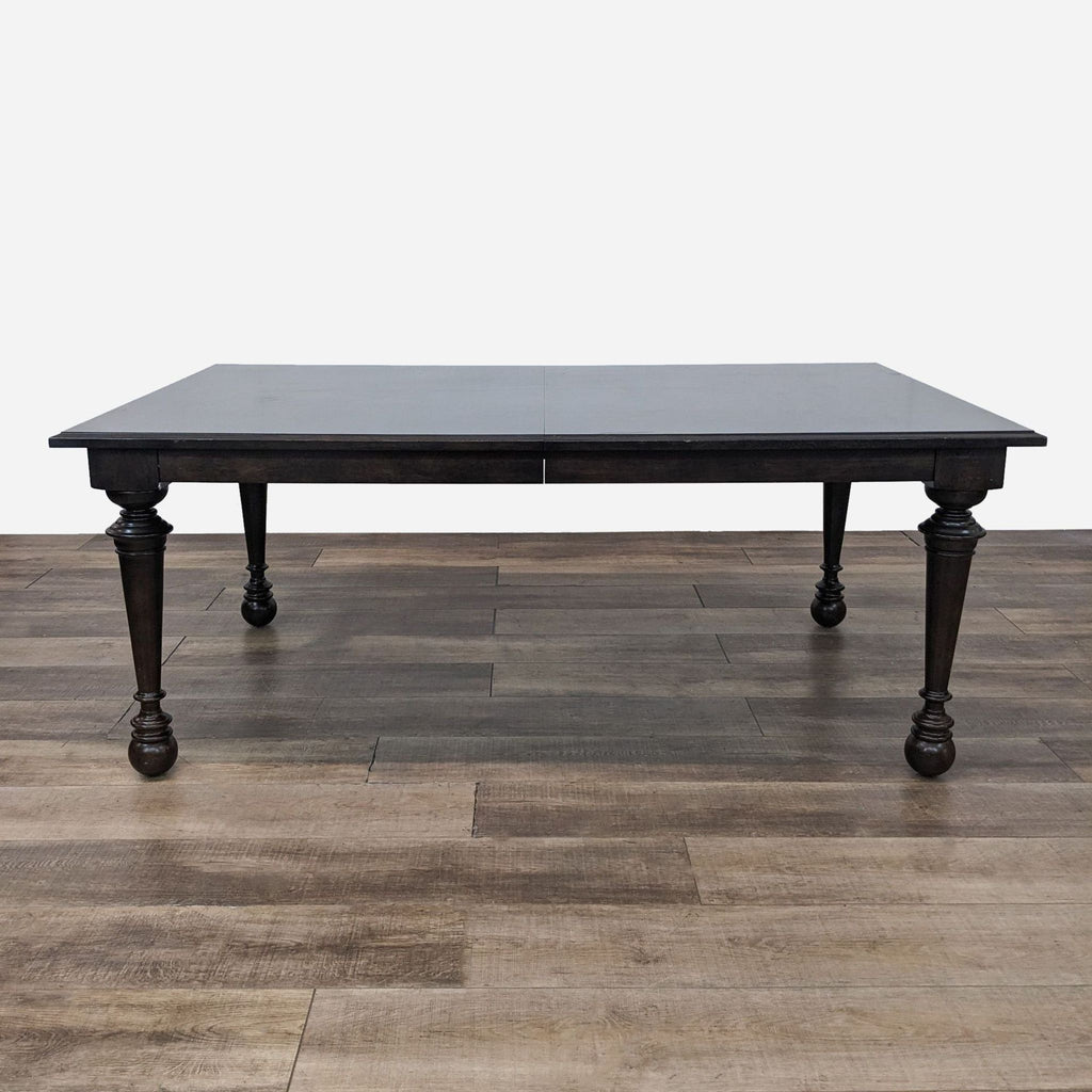 a black dining table with a dark brown finish.