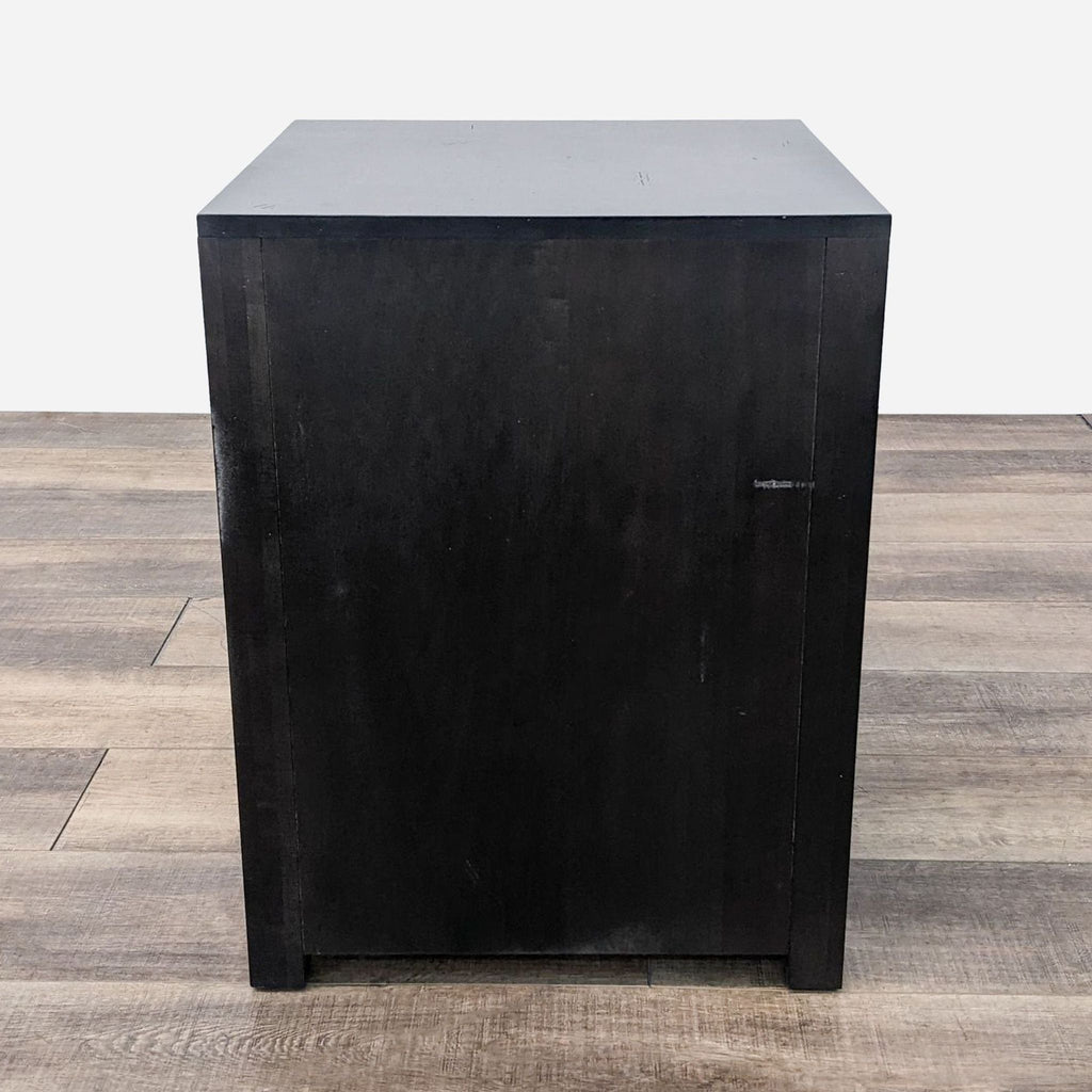 a black wood side table with a metal door