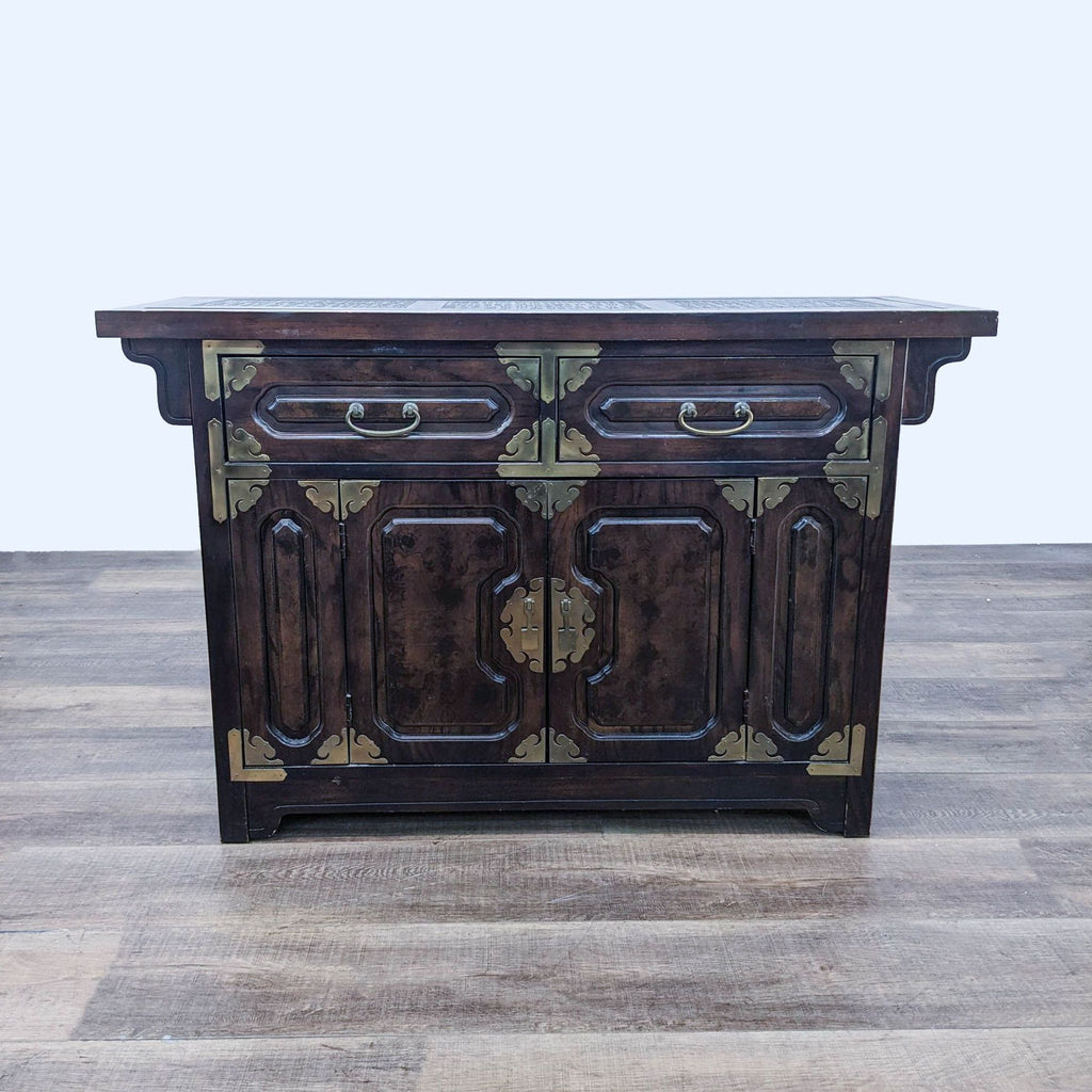 a chinese style sideboard with a carved wood top and a carved paneled top.