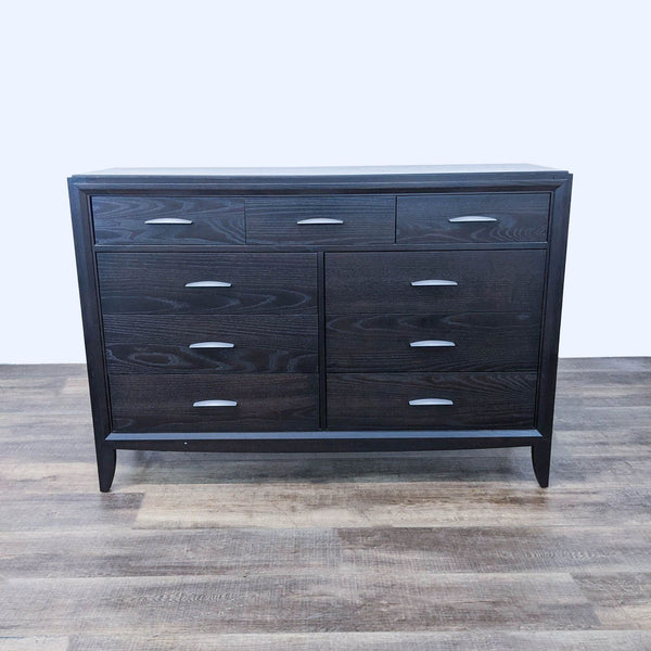 Sleek dark wood dresser with six drawers and silver handles.