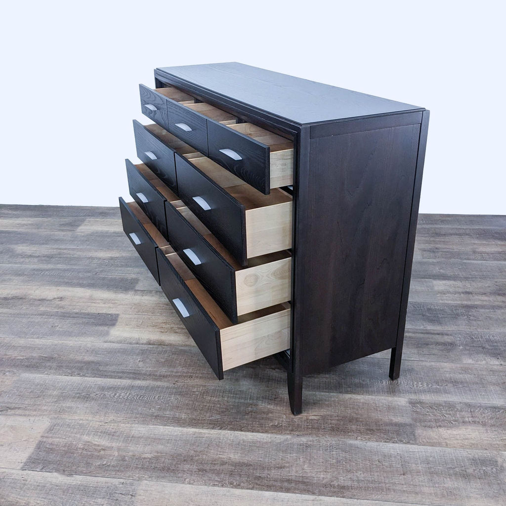 Dark wood dresser by Reperch, showcasing open and closed drawers.