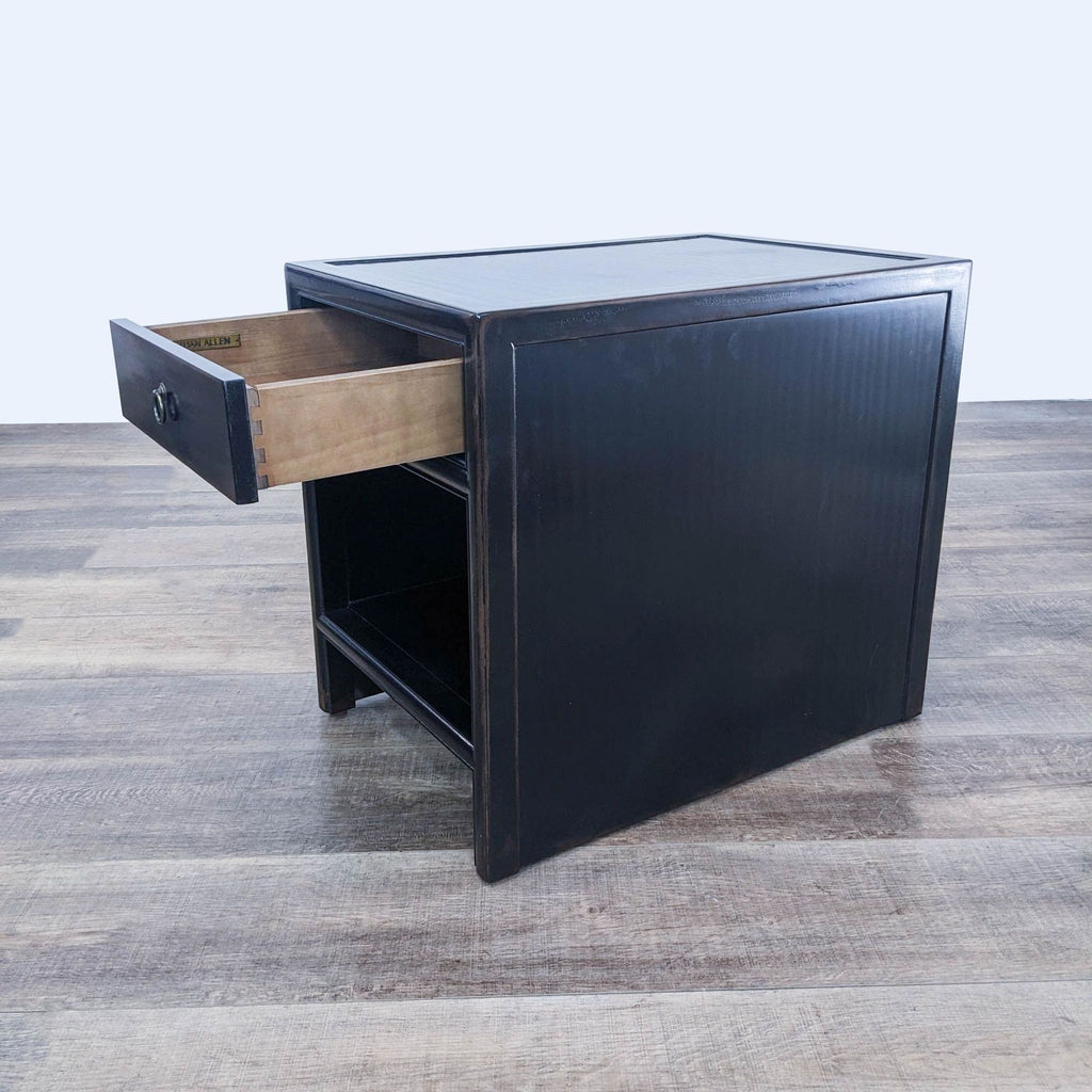 a black and brown side table with a drawer