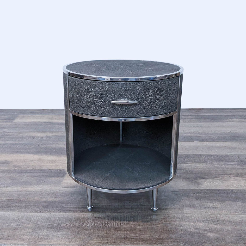 a chrome and black side table with a glass top.