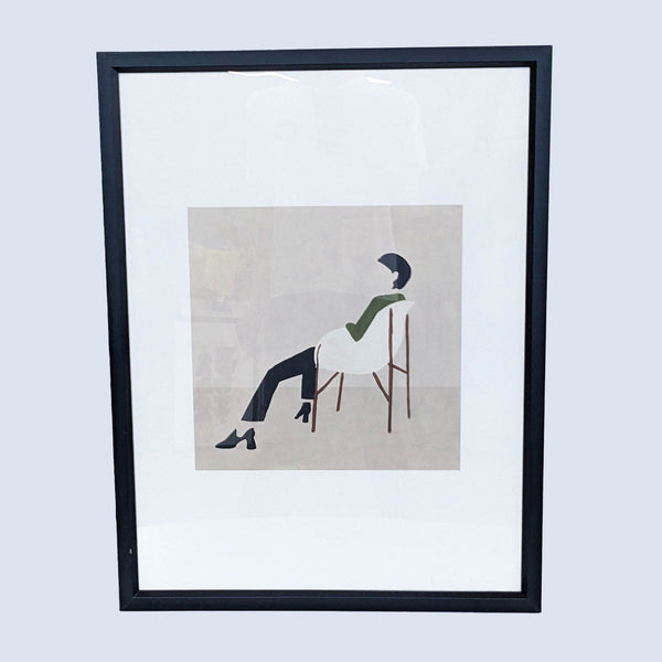 framed print of a man sitting on a chair