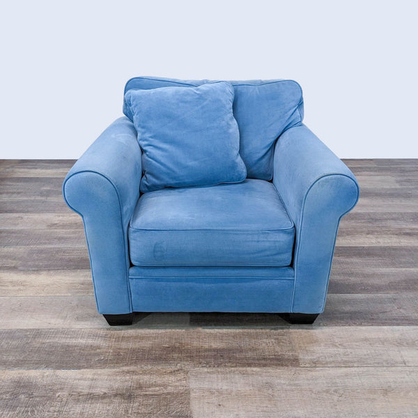 a blue chair with a black foot rest