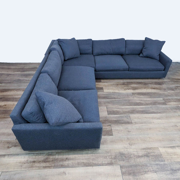 sofa is a modern design that is made of soft blue fabric. the sofa is made of a