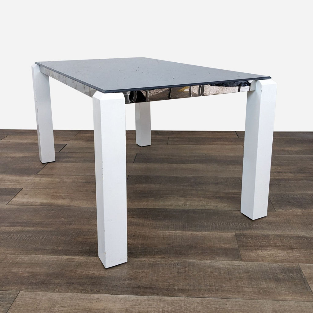 a white table with a black top and a white marble top.