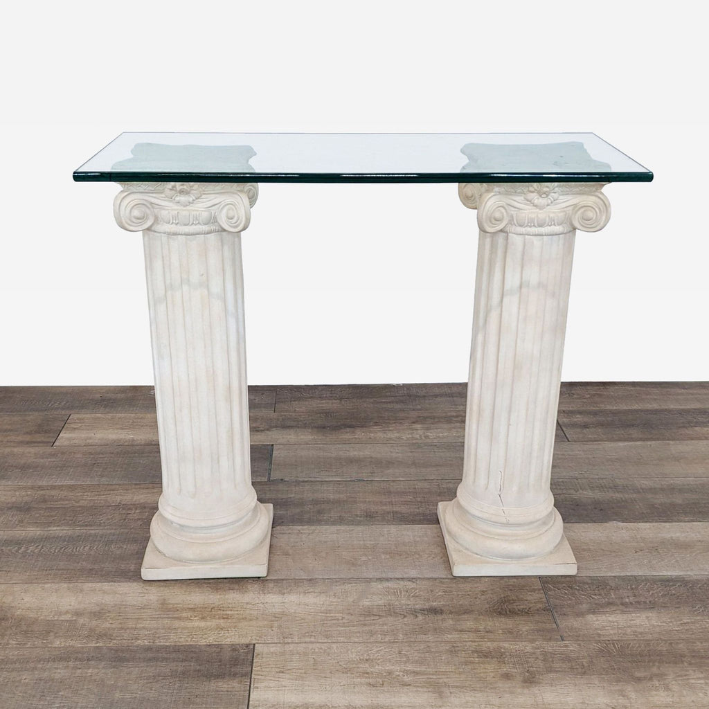 a pair of antique neoclassical style columns with glass top.