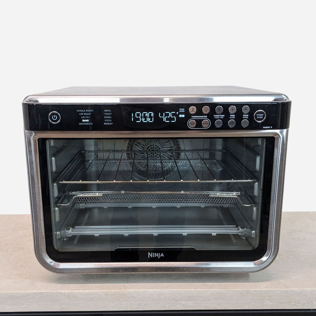 a small oven with a timer on the front.