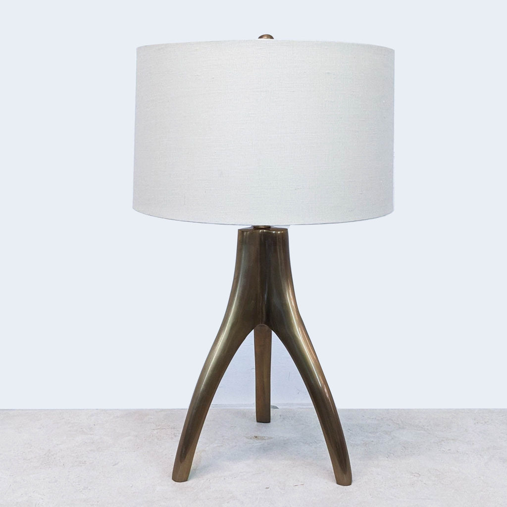 a brass table lamp with a brass base and a white linen shade.
