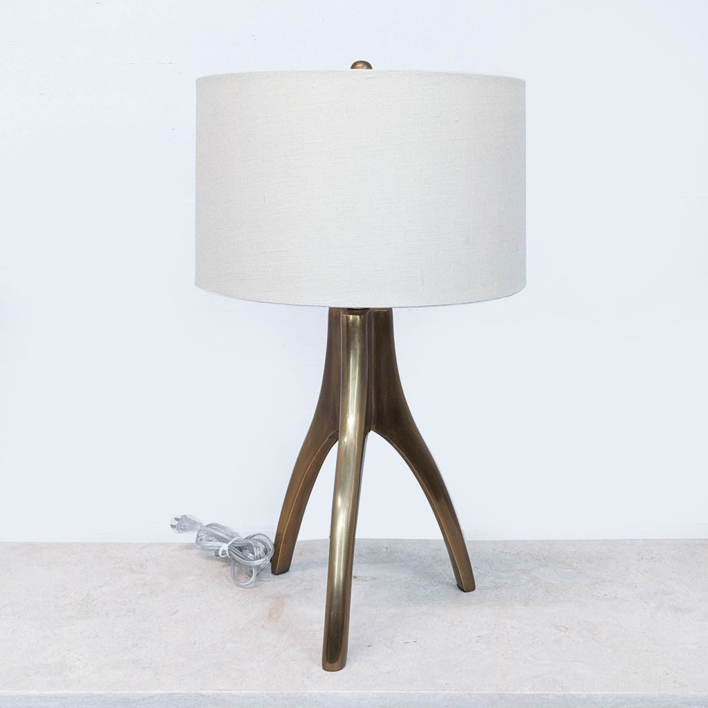 a brass table lamp with a brass base and a brass base.