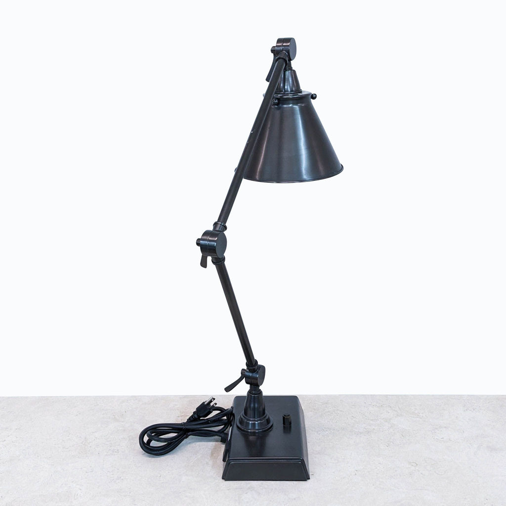 a black desk lamp by [ unused0 ], circa 1950.