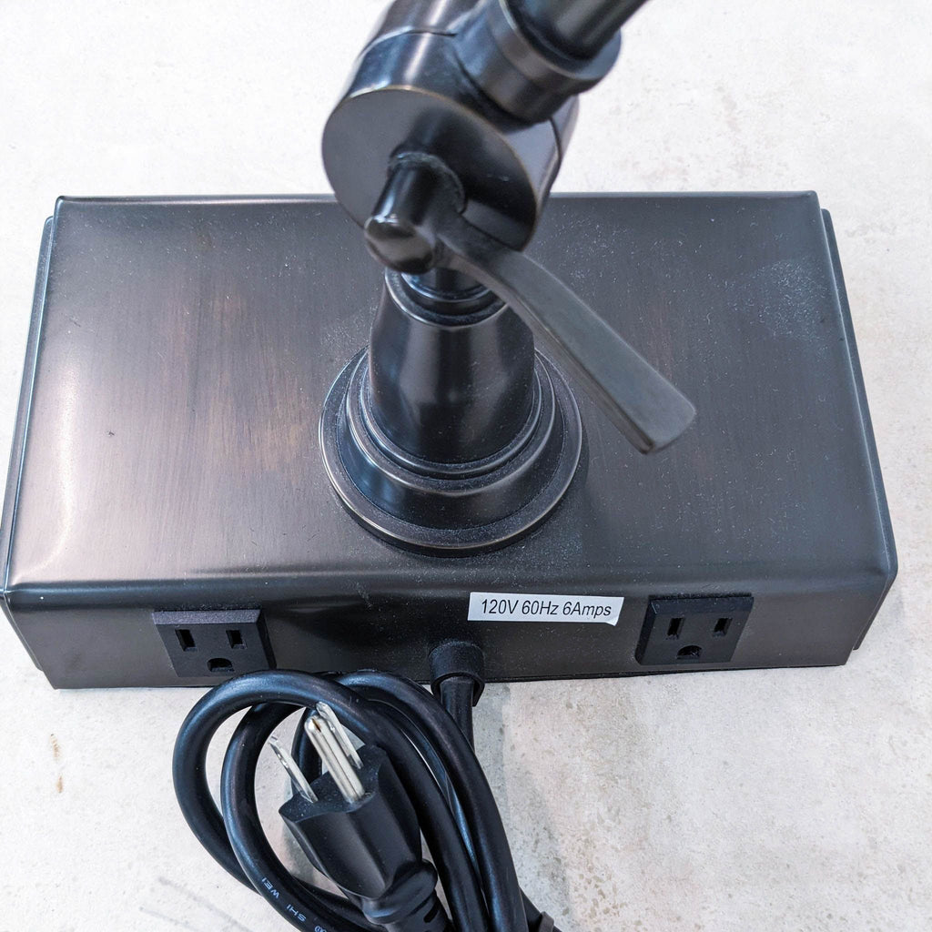 a close up of the power pole with the cable plugged in.