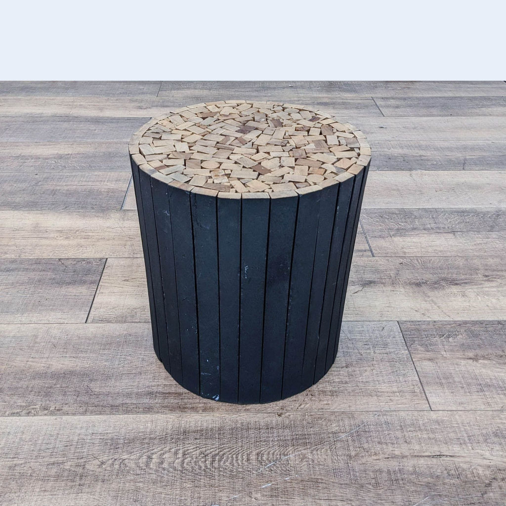 a black wooden stool with a wooden base.