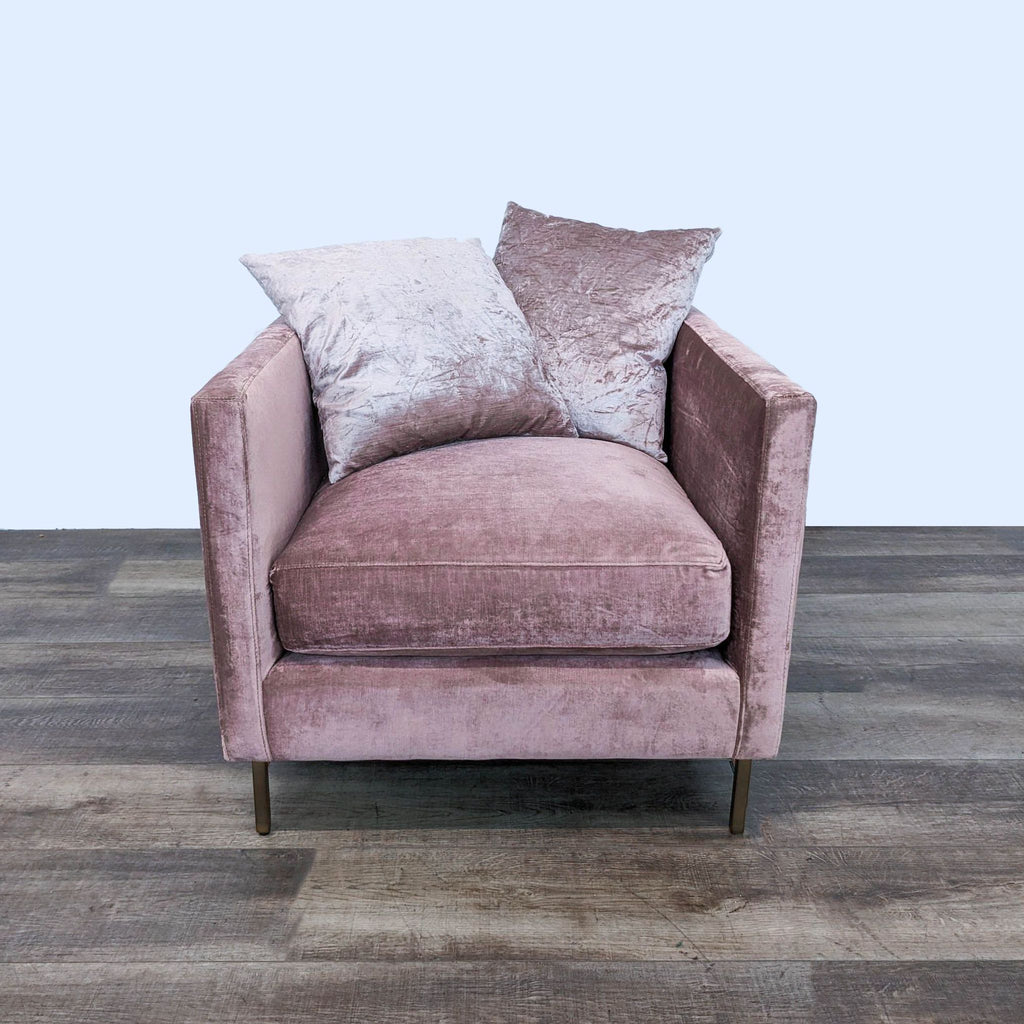 Emma chair in rosewood upholstery with wood legs and matching pillows on a wooden floor.