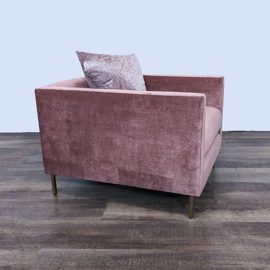 Side view of Emma chair, featuring rosewood upholstery, wood legs, and matching throw pillows.