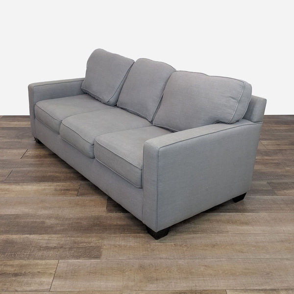 sofa is a modern sofa that is made of soft grey fabric. the sofa is made of soft