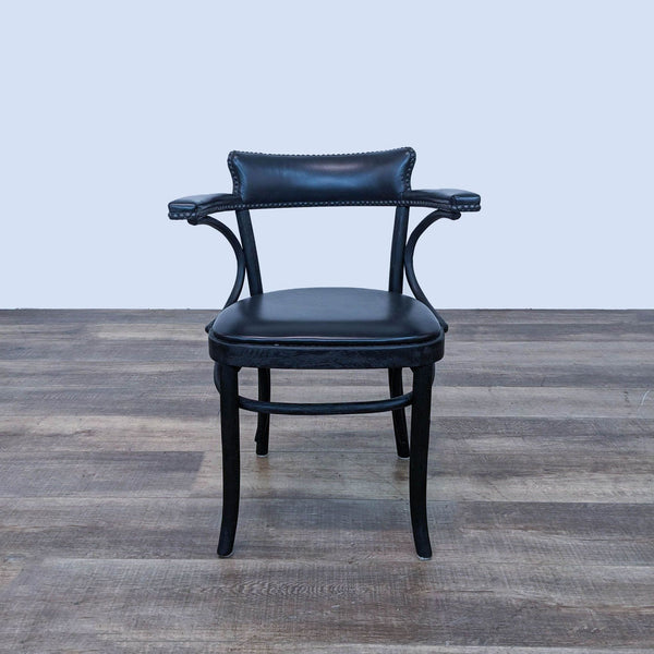 a pair of black leather armchairs