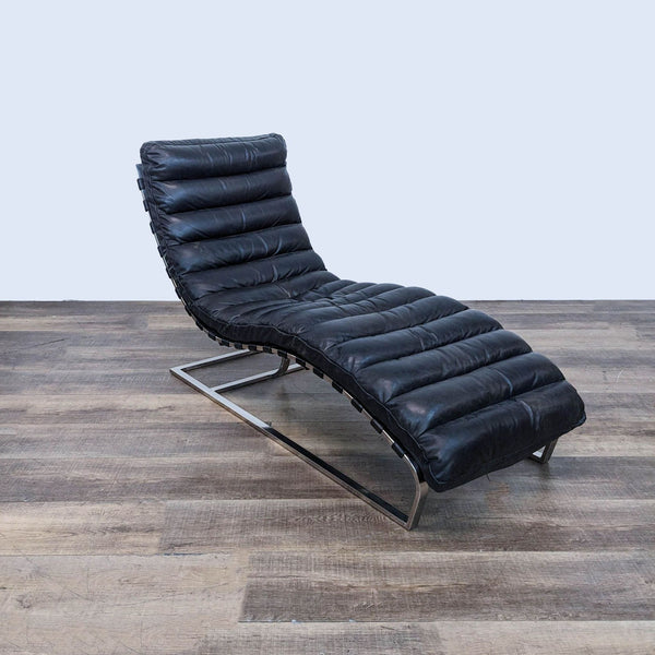 a black leather lounge chair by [ unused0 ] for [ unused0 ].