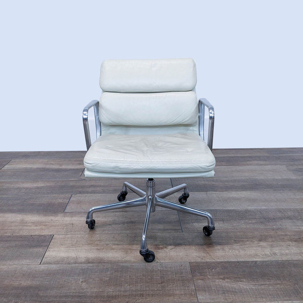 the office chair is made of leather and has a chrome frame.