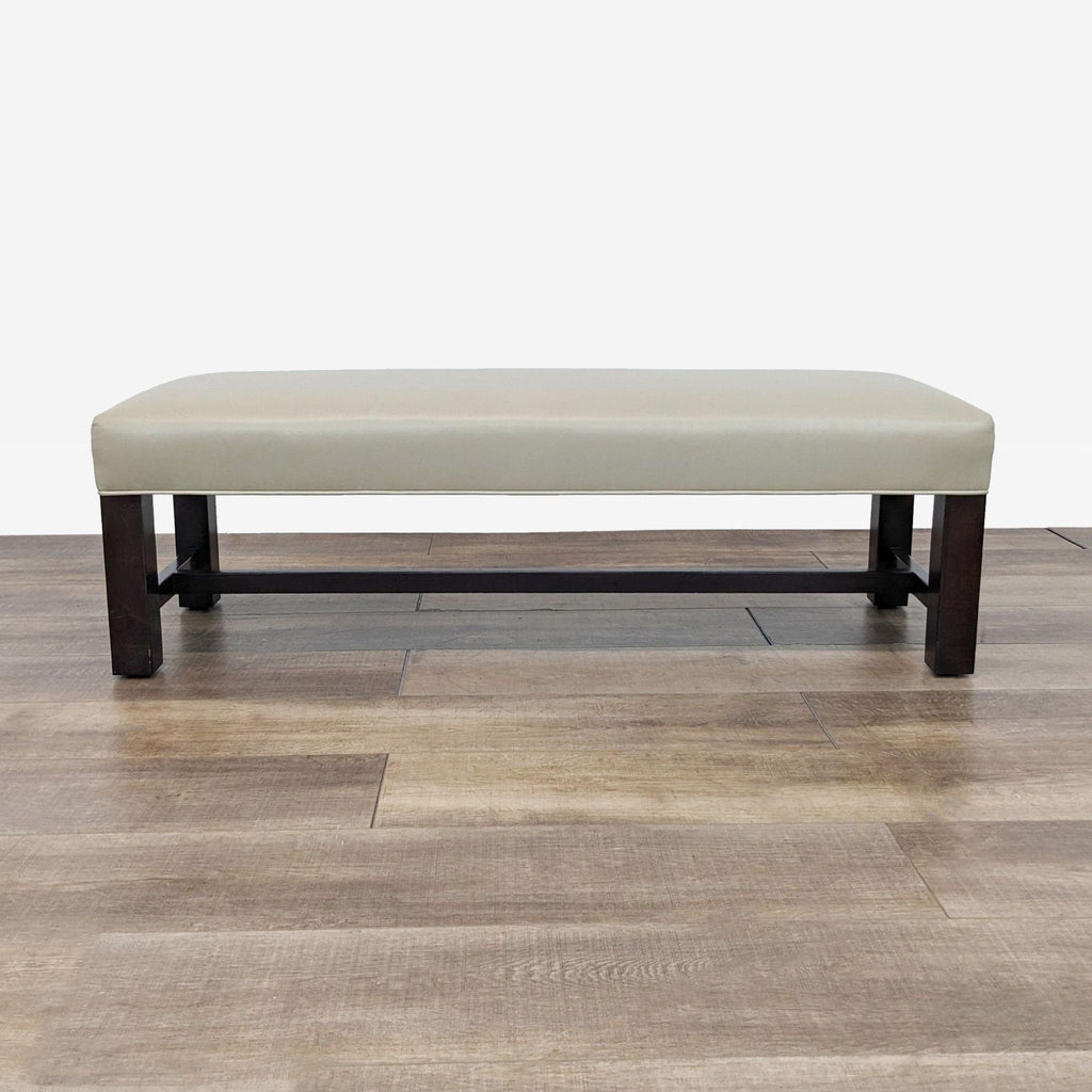 a bench with a light beige fabric