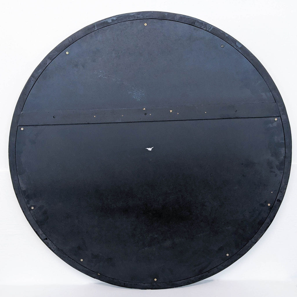 a large black metal shield with a metal frame.