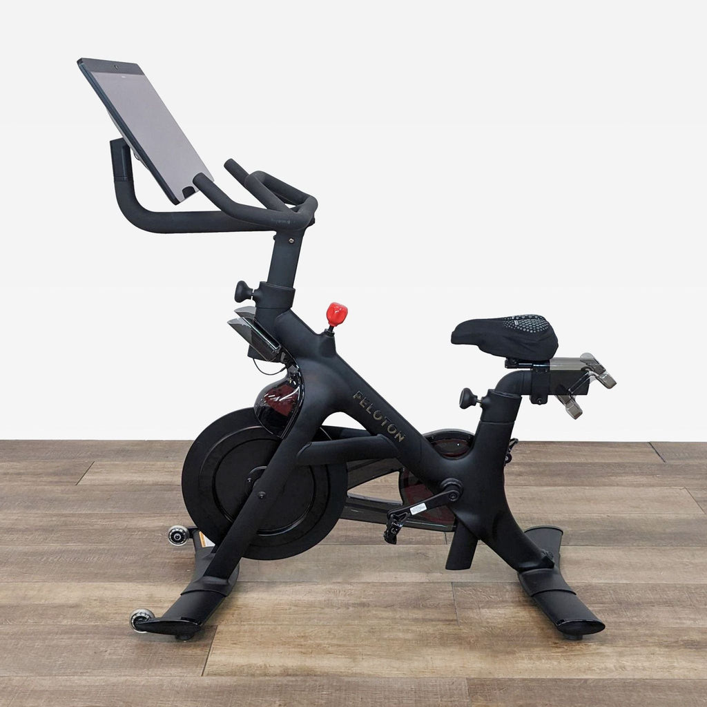 Peloton Exercise Bike with touchscreen for immersive fitness classes, ergonomic design, and silent operation.