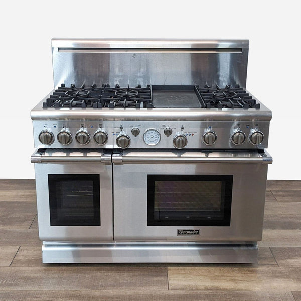 a stainless steel gas stove with four burners.