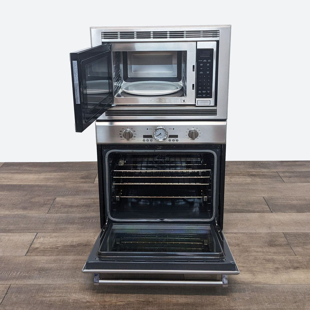 a stainless steel oven with a door open on a wooden table.